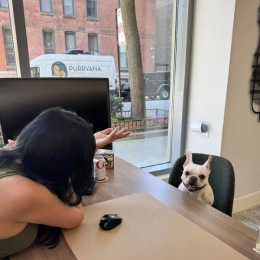 a woman with a dog in a office