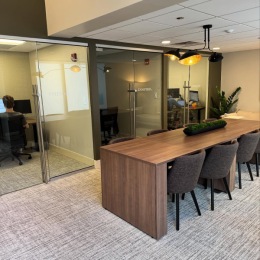 The essence of exceptional living community co-working area with private offices and large table with seating