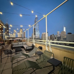 A beautiful community at the heart of all your passions a rooftop patio at night with view of a city
