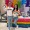 people holding rainbow fans in front of a display