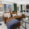 living room with tv couch and view of a kitchen