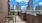 a grill area on a balcony with a city view