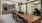 a clubhouse room with a coffee station, a table and chairs