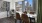 a table with chairs and a window with a view of a city